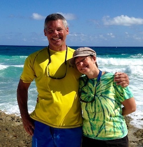 Tony and Joni grinning on a beach